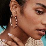 A woman with a large round hoop earring.